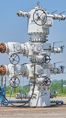 Modern wellhead for oil storage with integrated components.